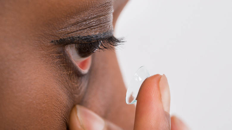 A woman putting in contacts