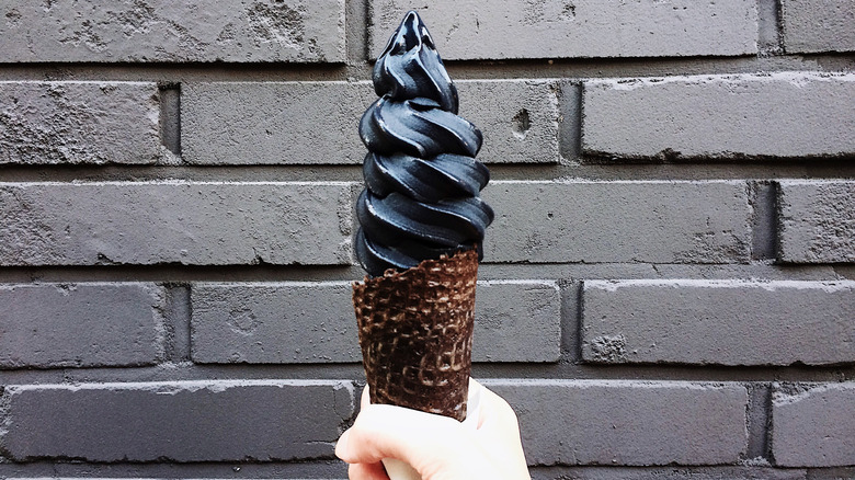 Hand holding charcoal ice cream
