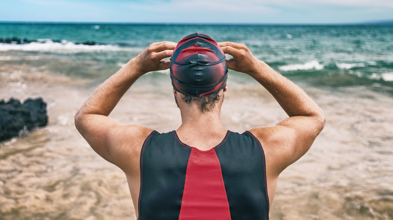 swimmer standing on beach