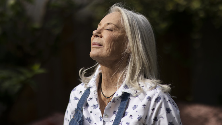 mature woman enjoying time outside in the sunlight