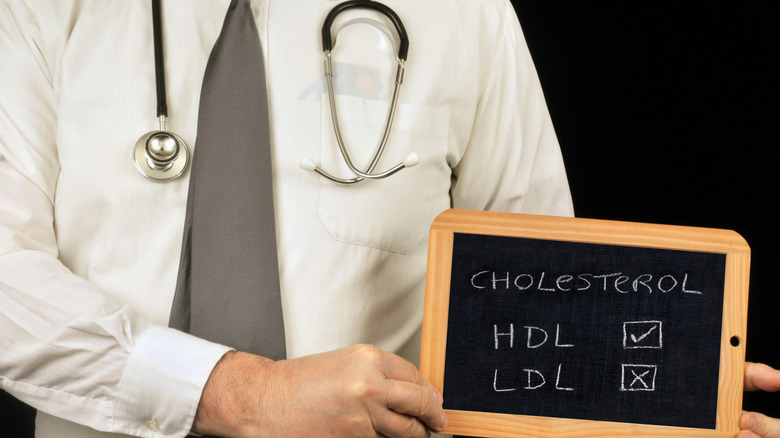 doctor holding clipboard with HDL and LDL cholesterol