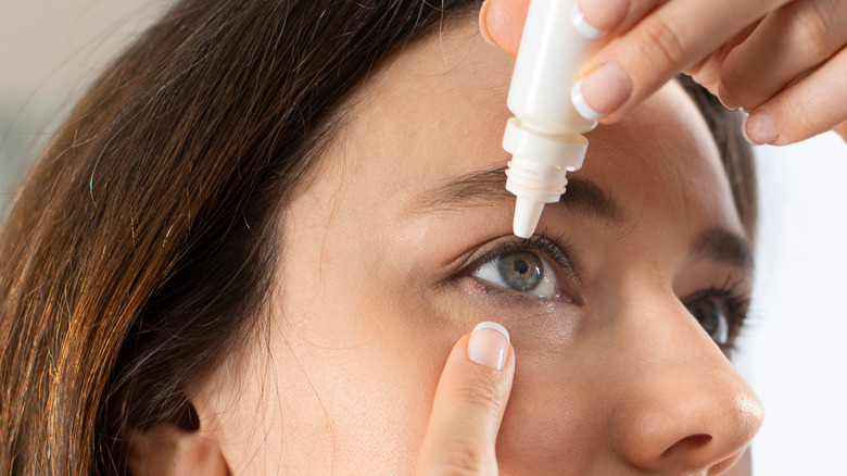 Woman using artificial tears for dry eyes