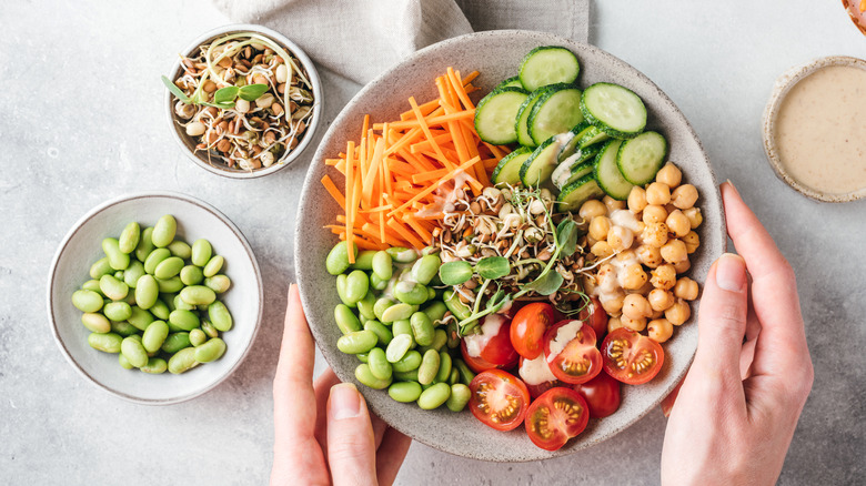 Buddha bowl with chickpeas, edamame, tomatoes and carrots
