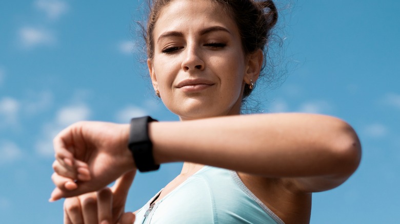 Athletic woman checking heart rate outdoors