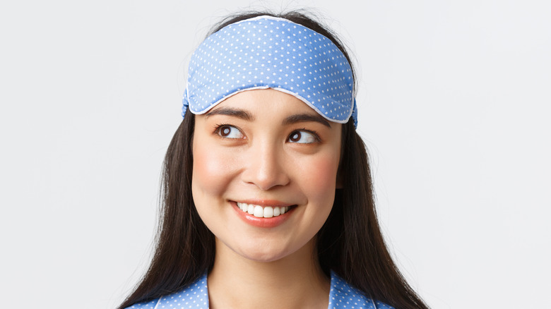 Smiling woman with eye mask