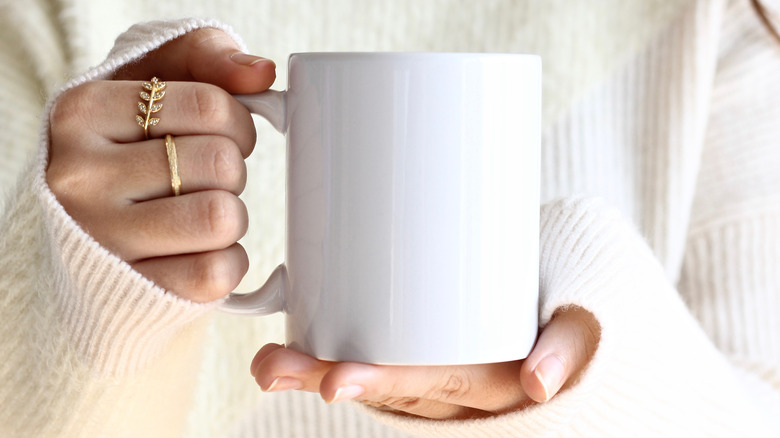 woman holding mug of coffee