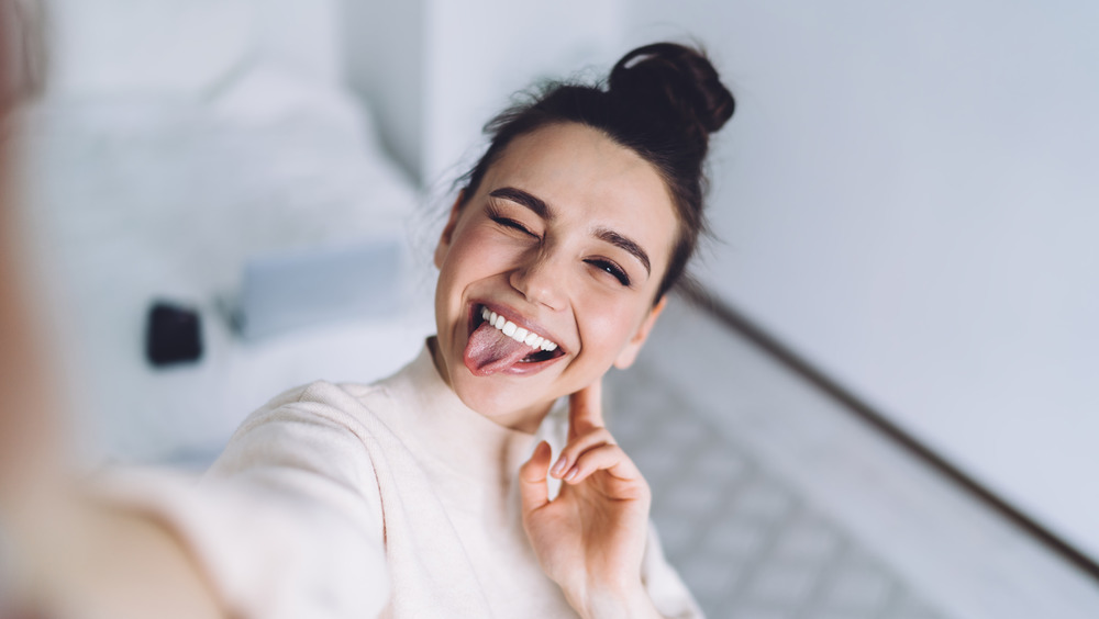 Woman taking a selfie with her tongue out 