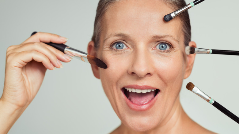 woman applying makeup