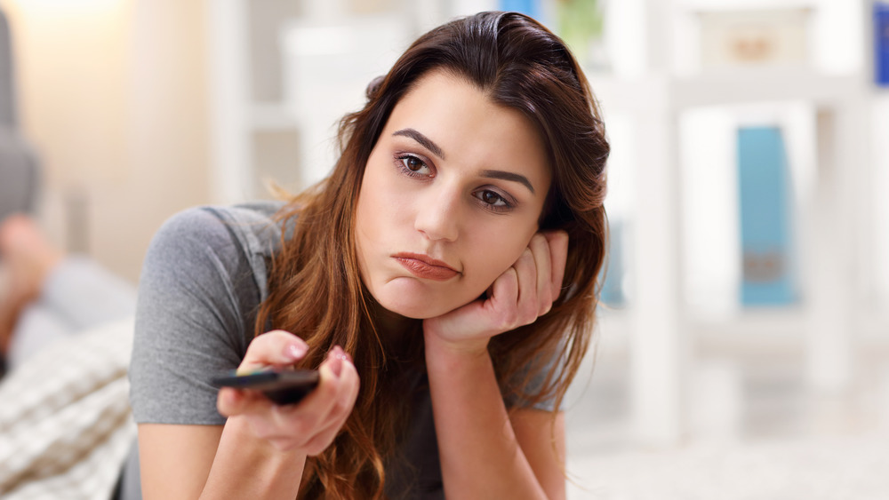 woman flipping through channels