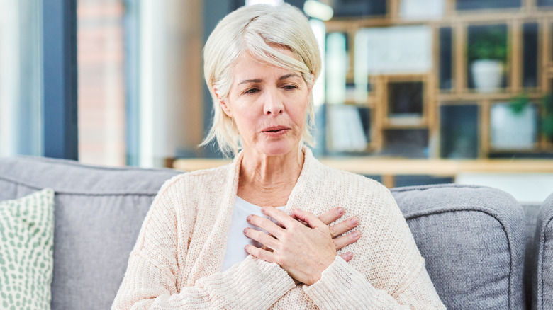 Woman holding hands to heart