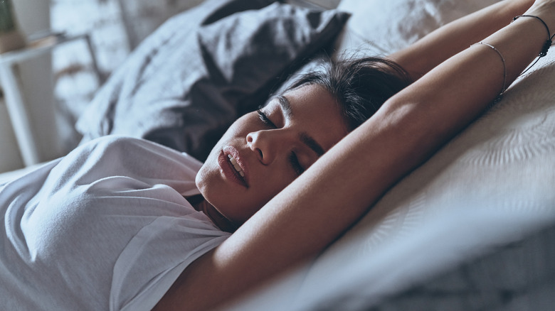 Woman stretching in bed