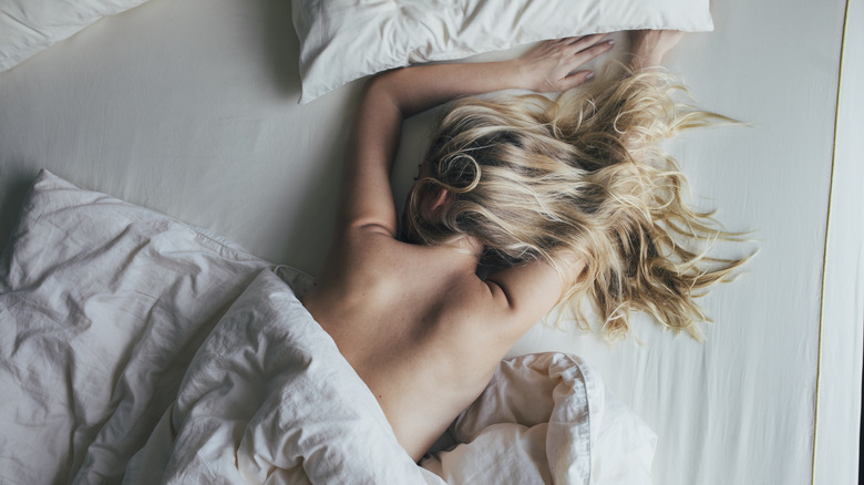 Woman sleeping on stomach