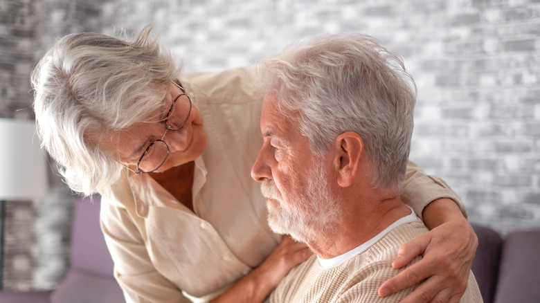 older woman embracing older man with dementia