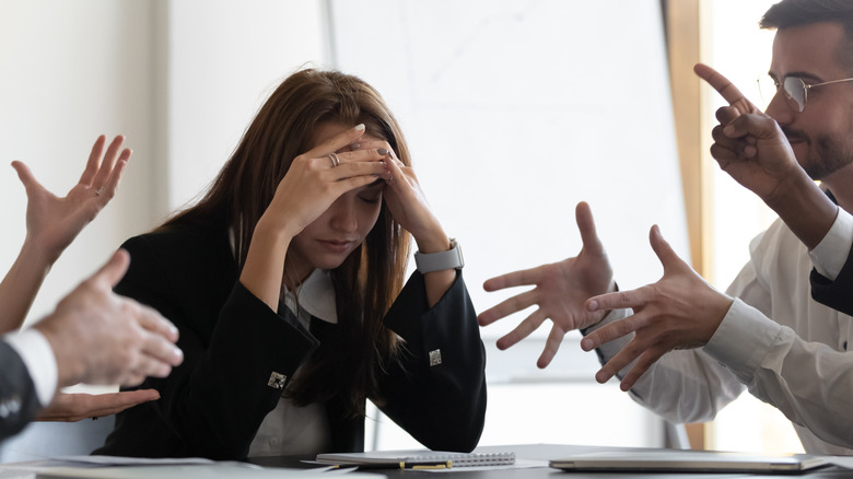Confused woman in office meeting