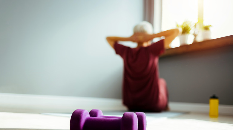 Person doing crunches in background