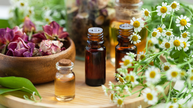 bottled oils surrounded by flowers