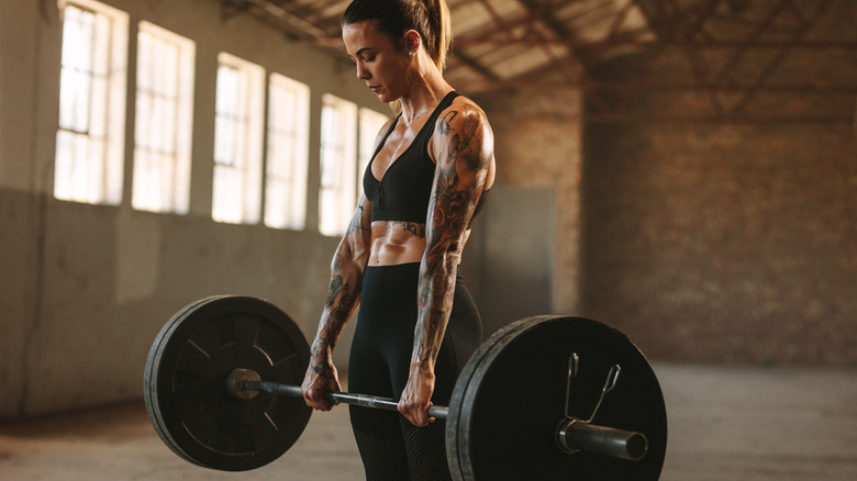 A woman performing a deadlift