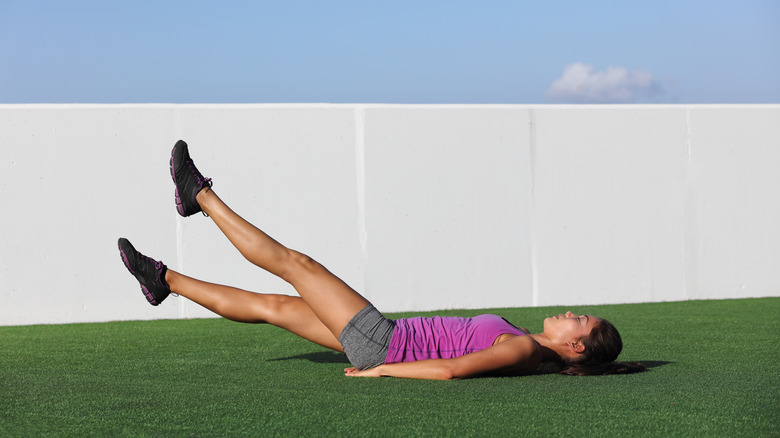 Woman doing scissor lifts leg raise 