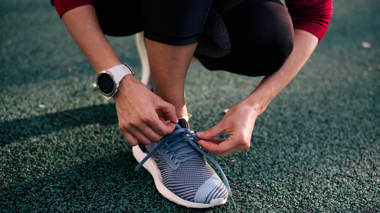 Woman tying sneakers